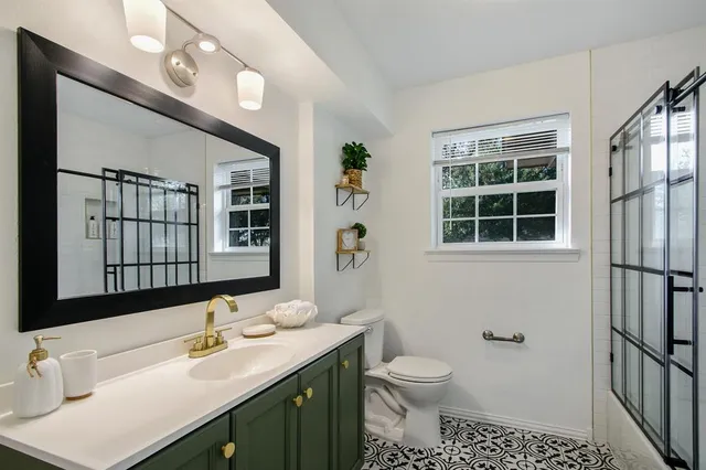 a bathroom with a sink toilet and shower