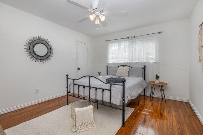 2404 Crestview Circle Irving, TX 75062 - Photo 20 of 39 a spacious bedroom with a bed and a chandelier