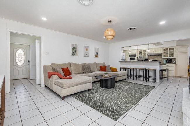 2404 Crestview Circle Irving, TX 75062 - Photo 7 of 39 a living room with furniture a rug and kitchen view