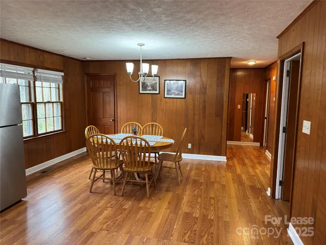 a view of a dining room with furniture and window