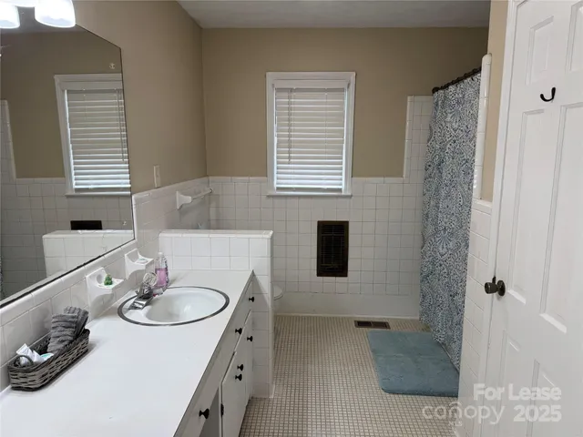 a bathroom with a sink double vanity and a mirror