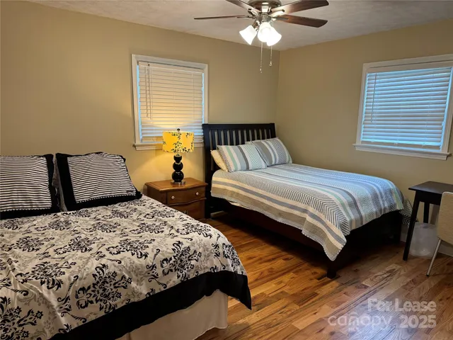 a bedroom with two beds and a chandelier