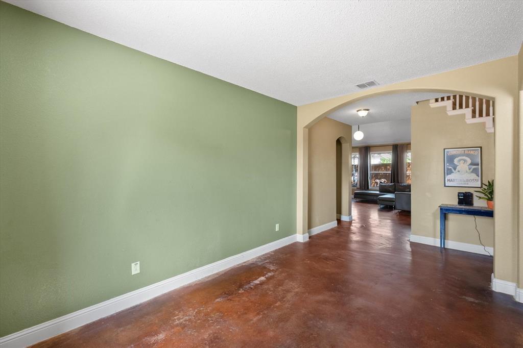 1305 Liverpool Lane Mansfield, TX 76063 - Photo 9 of 40 This expansive room features a wide entryway with an arched design, rich brown flooring, and light green walls
