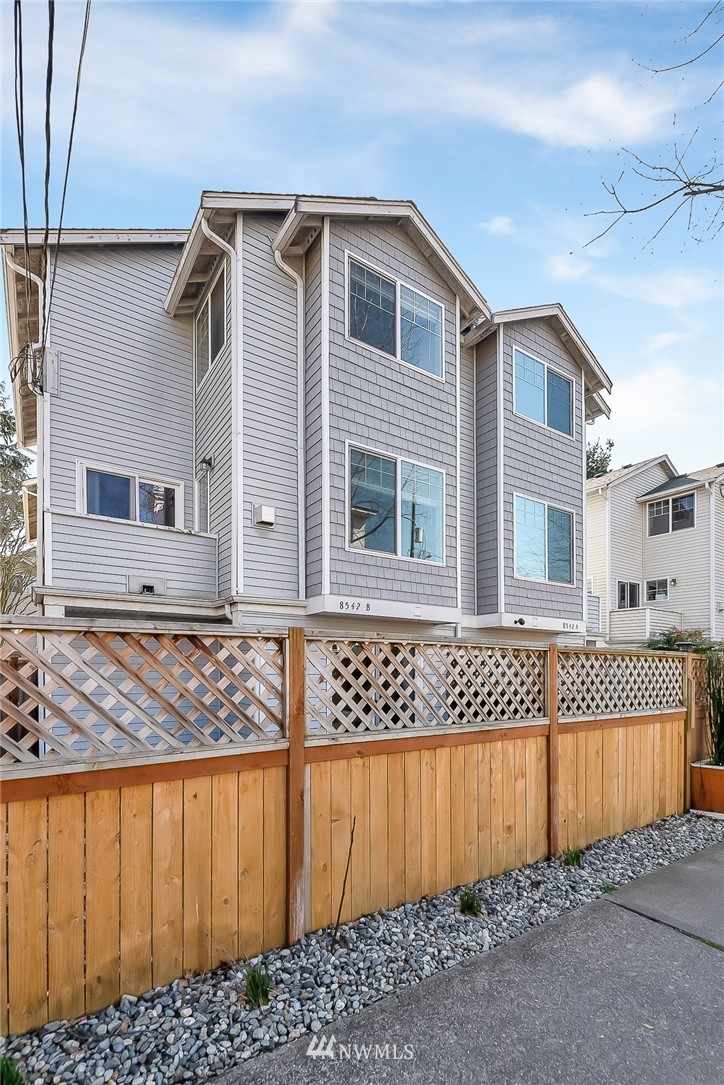 a front view of a house with a wooden fence