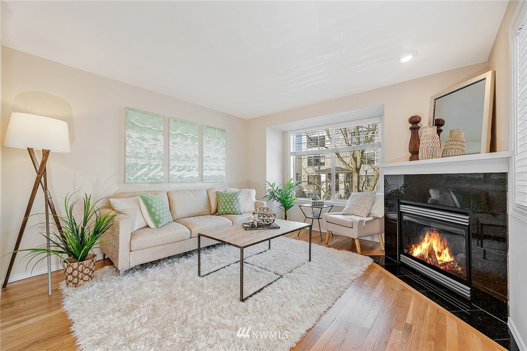 8542 B Midvale Avenue North Seattle, WA 98103 - Photo 2 of 31 a living room with furniture a flat screen tv and a fireplace