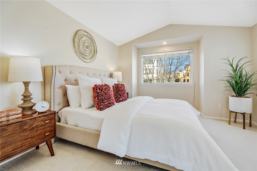 8542 B Midvale Avenue North Seattle, WA 98103 - Photo 13 of 31 a bedroom with a bed and a potted plant on dresser