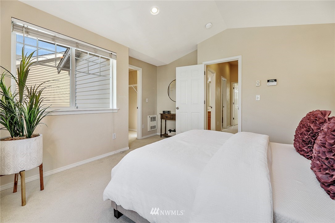 8542 B Midvale Avenue North Seattle, WA 98103 - Photo 14 of 31 a bedroom with a large bed and a window