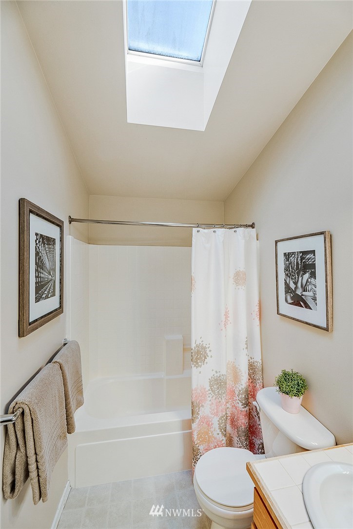 8542 B Midvale Avenue North Seattle, WA 98103 - Photo 17 of 31 a white toilet sitting next to a bath tub