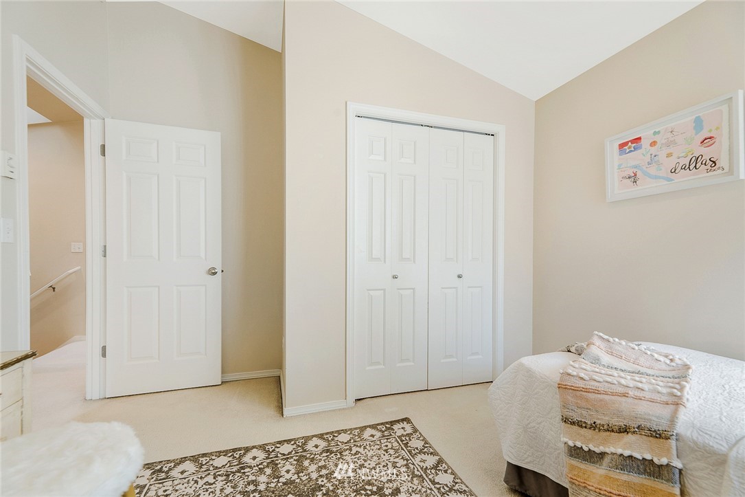8542 B Midvale Avenue North Seattle, WA 98103 - Photo 20 of 31 a bedroom with a bed and a rug