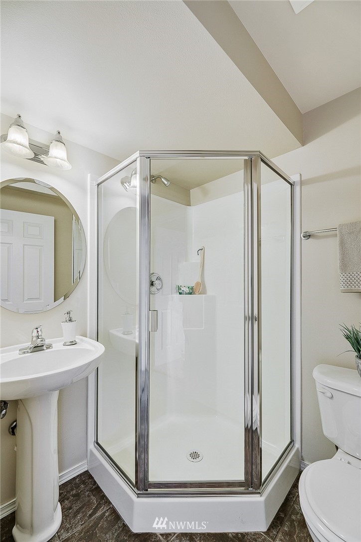 8542 B Midvale Avenue North Seattle, WA 98103 - Photo 25 of 31 a bathroom with a shower sink vanity and toilet