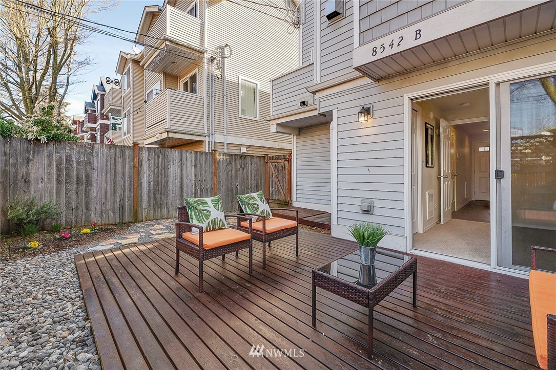 8542 B Midvale Avenue North Seattle, WA 98103 - Photo 29 of 31 a view of a patio with table and chairs potted plants and wooden floor