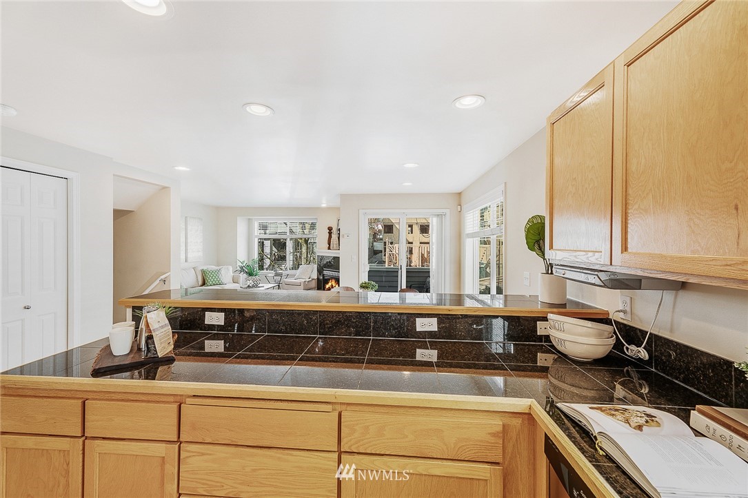 8542 B Midvale Avenue North Seattle, WA 98103 - Photo 8 of 31 a kitchen with kitchen island granite countertop a sink and cabinets