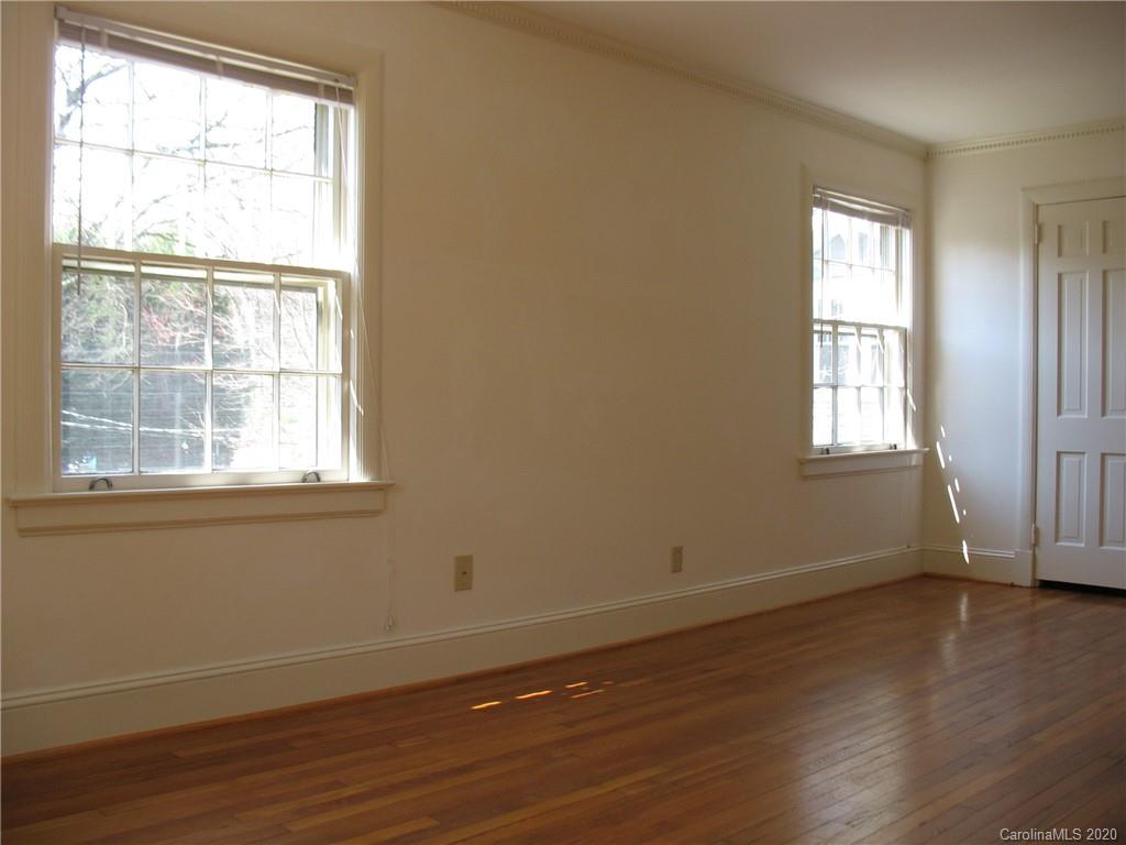 3043 Park Road Charlotte, NC 28209 - Photo 2 of 9 an empty room with wooden floor and windows