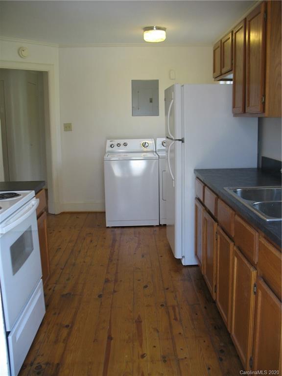 3043 Park Road Charlotte, NC 28209 - Photo 6 of 9 a kitchen with a refrigerator and a stove top oven