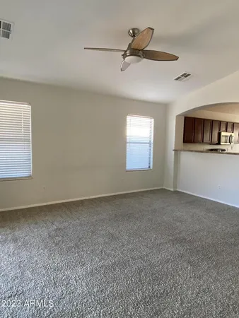 a view of a livingroom with a ceiling fan and window