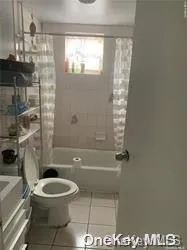 a bathroom with a toilet a sink and shower