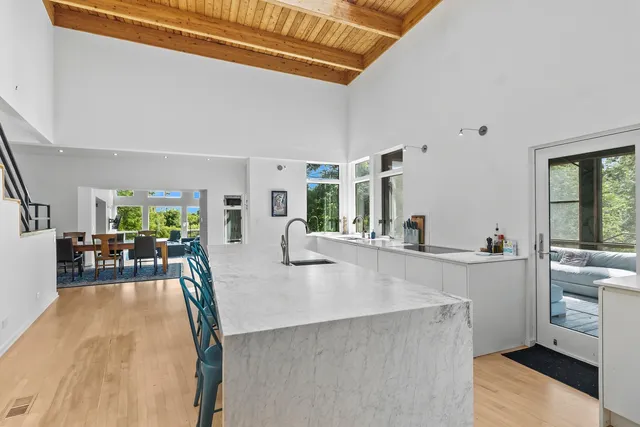 a kitchen with stainless steel appliances granite countertop lots of counter top space and furniture