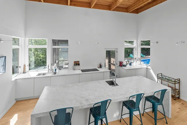a kitchen with white cabinets and white appliances