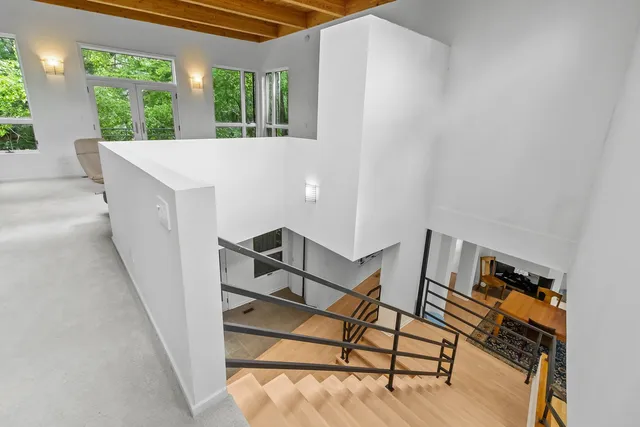 a living room with furniture and floor to ceiling windows