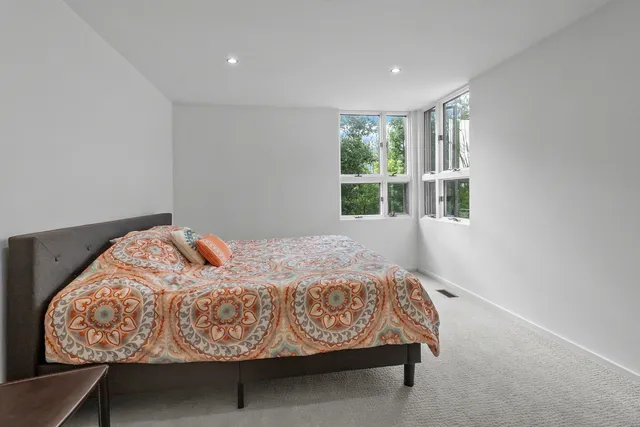 a bathroom with a white tub shower vanity and a toilet