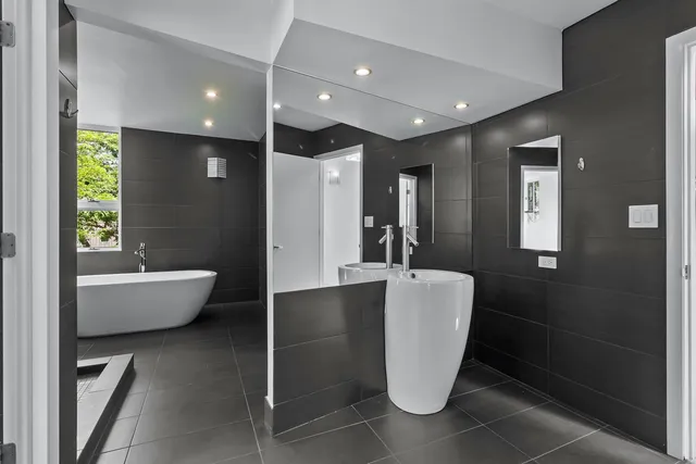 a bathroom with a toilet sink and mirror