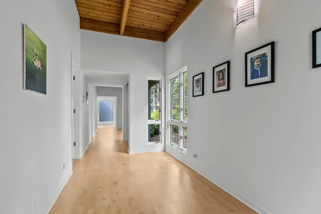 a bedroom with double bed and a large window
