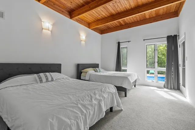 a bedroom with a large bed and a chandelier