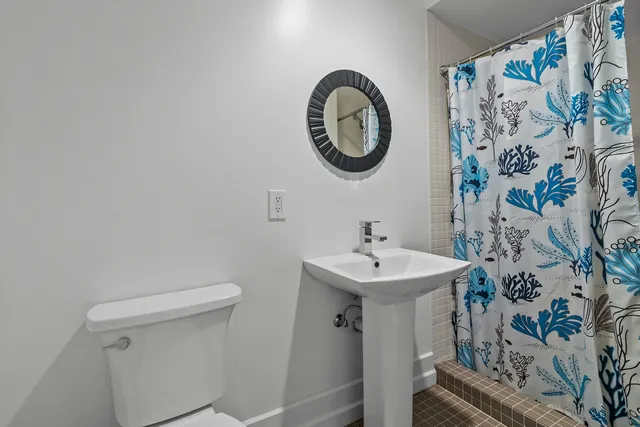 a bedroom with furniture and a large window