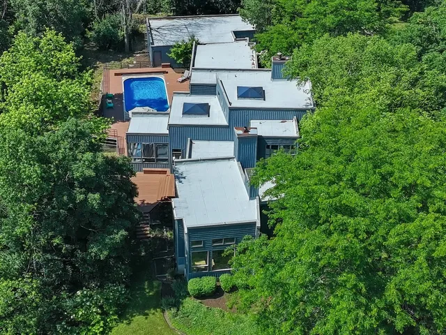 an aerial view of a house with a yard