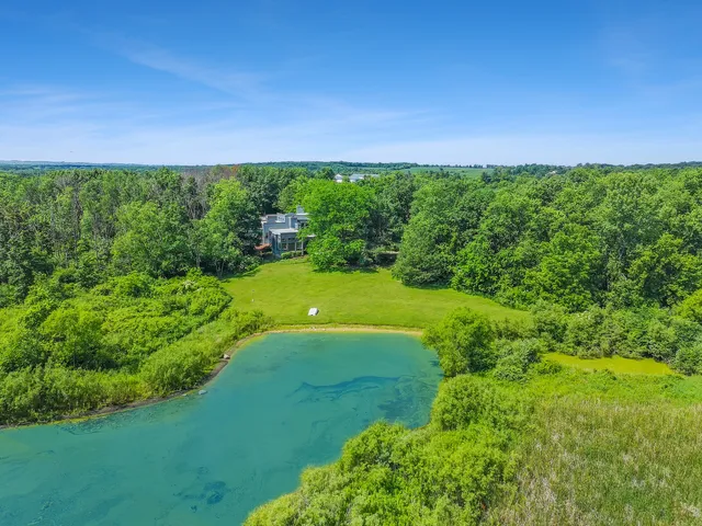 a view of a house with swimming pool and sitting area