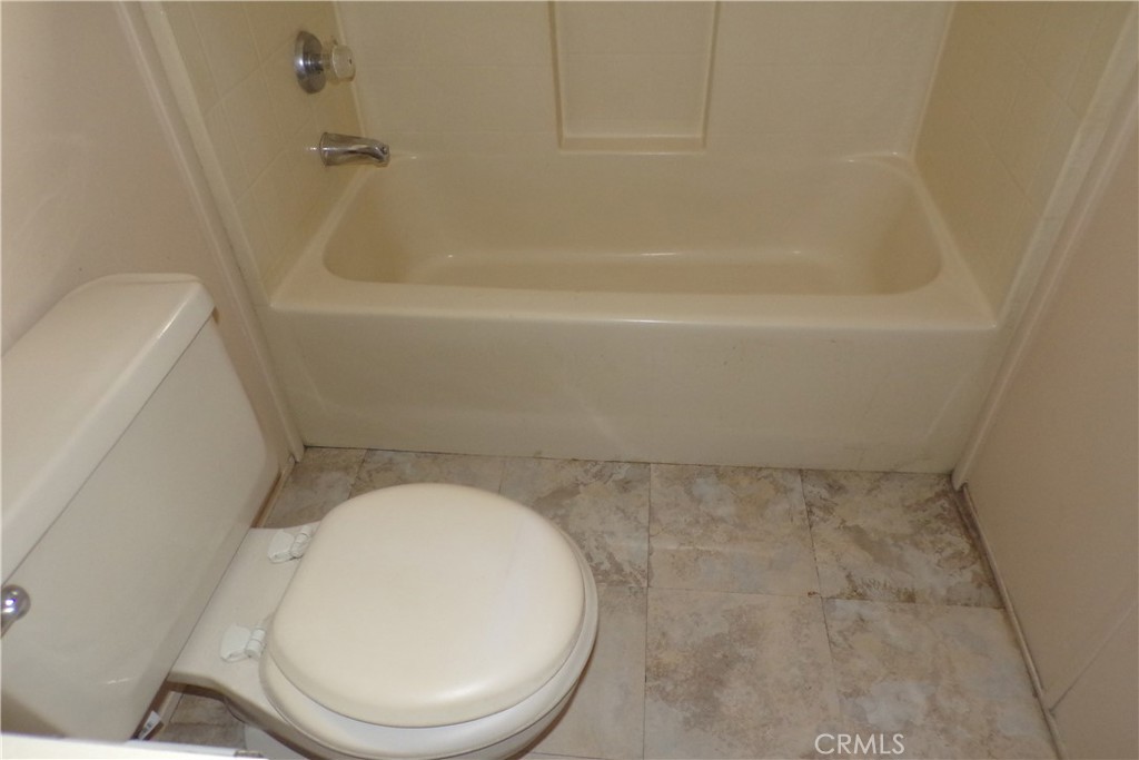 34447 Yucaipa Boulevard, Unit 2 Yucaipa, CA 92399 - Photo 12 of 16 a bathroom with a toilet and a bathtub