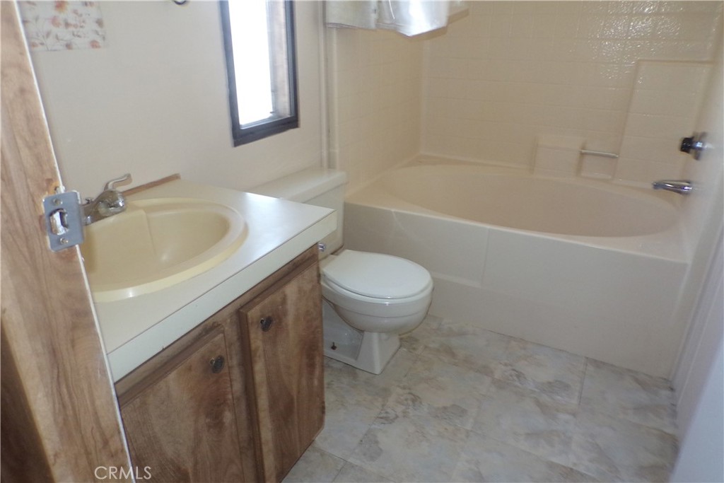 34447 Yucaipa Boulevard, Unit 2 Yucaipa, CA 92399 - Photo 16 of 16 a bathroom with a sink toilet and bathtub