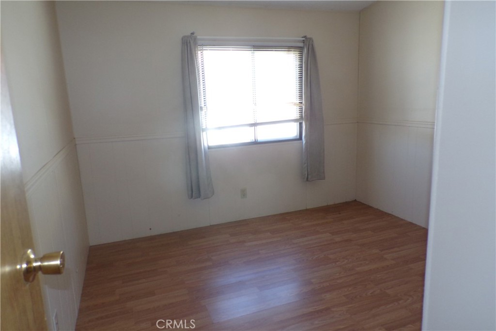 34447 Yucaipa Boulevard, Unit 2 Yucaipa, CA 92399 - Photo 6 of 16 an empty room with a window