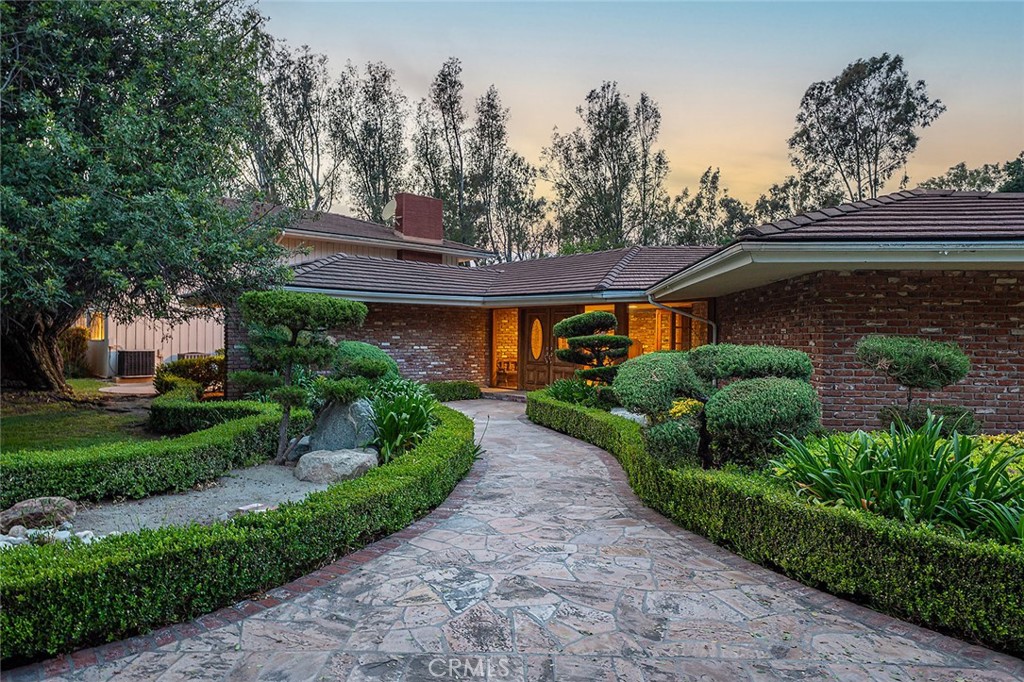 20827 East Mesarica Road Covina, CA 91724 - Photo 2 of 40 a front view of a house with a garden