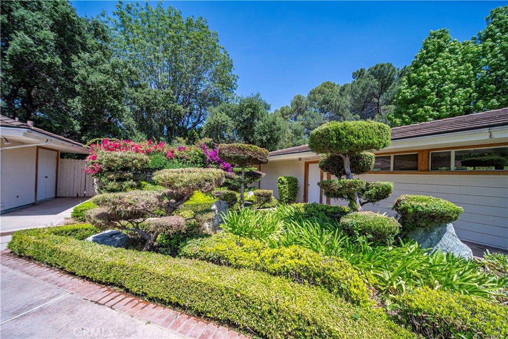 20827 East Mesarica Road Covina, CA 91724 - Photo 29 of 40 a front view of a house with a yard and potted plants