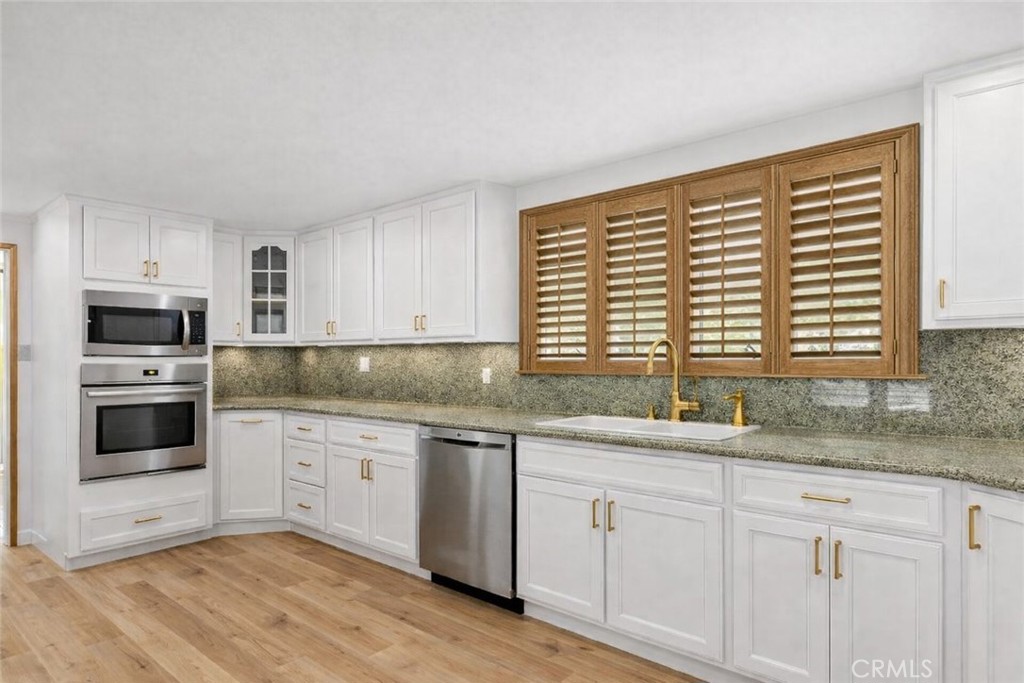 20827 East Mesarica Road Covina, CA 91724 - Photo 4 of 40 a kitchen with granite countertop stainless steel appliances a sink and cabinets