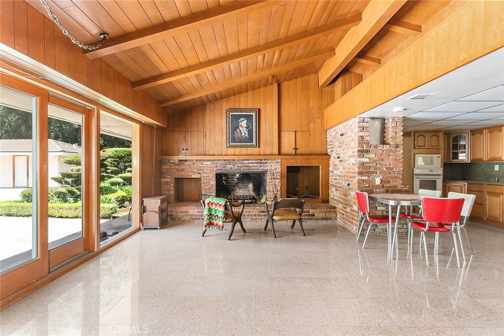 20827 East Mesarica Road Covina, CA 91724 - Photo 7 of 40 a dining room with furniture a fireplace and outside view