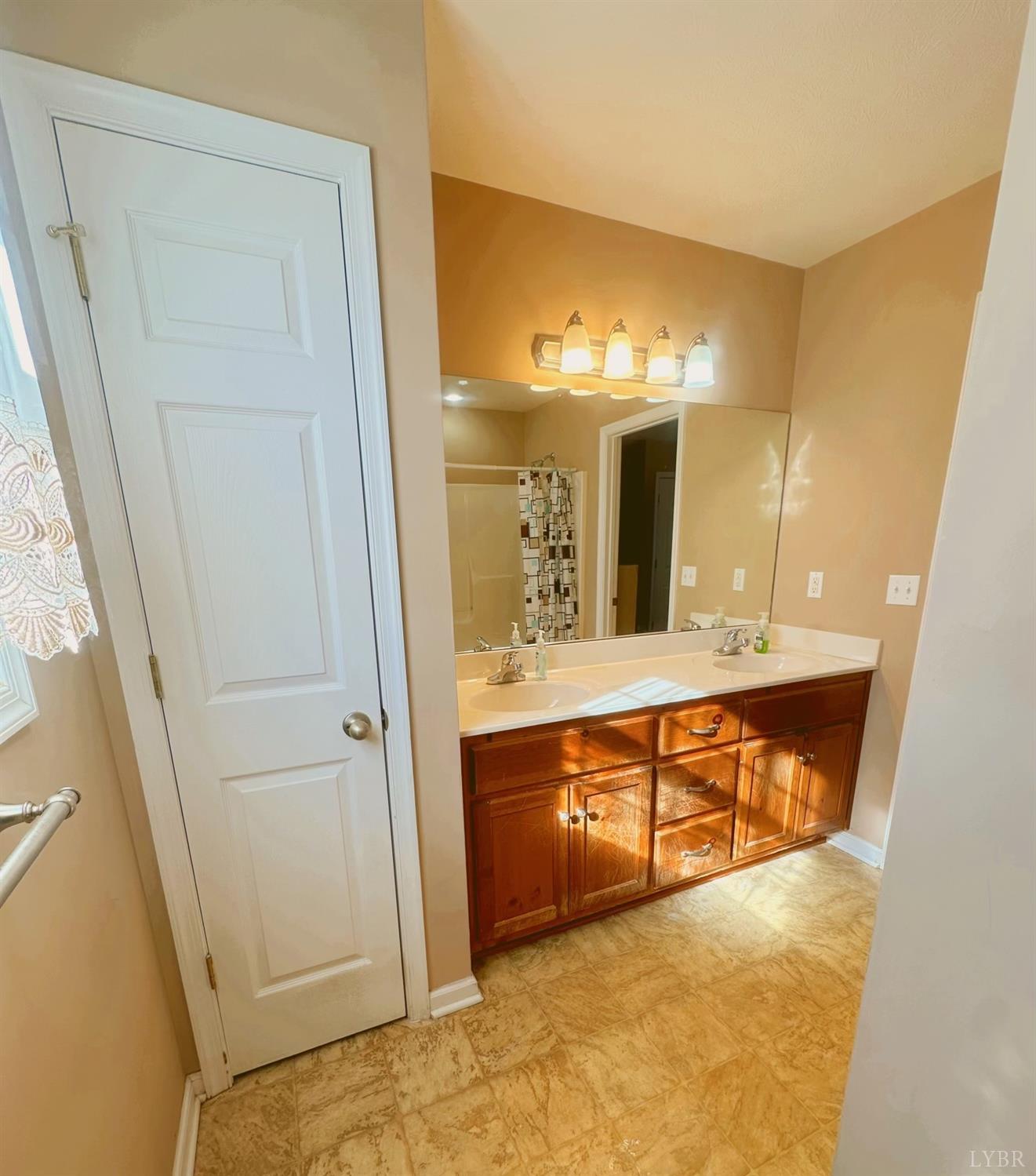 283 Country Estates Road Appomattox, VA 24522 - Photo 14 of 22 a bathroom with a sink and a mirror