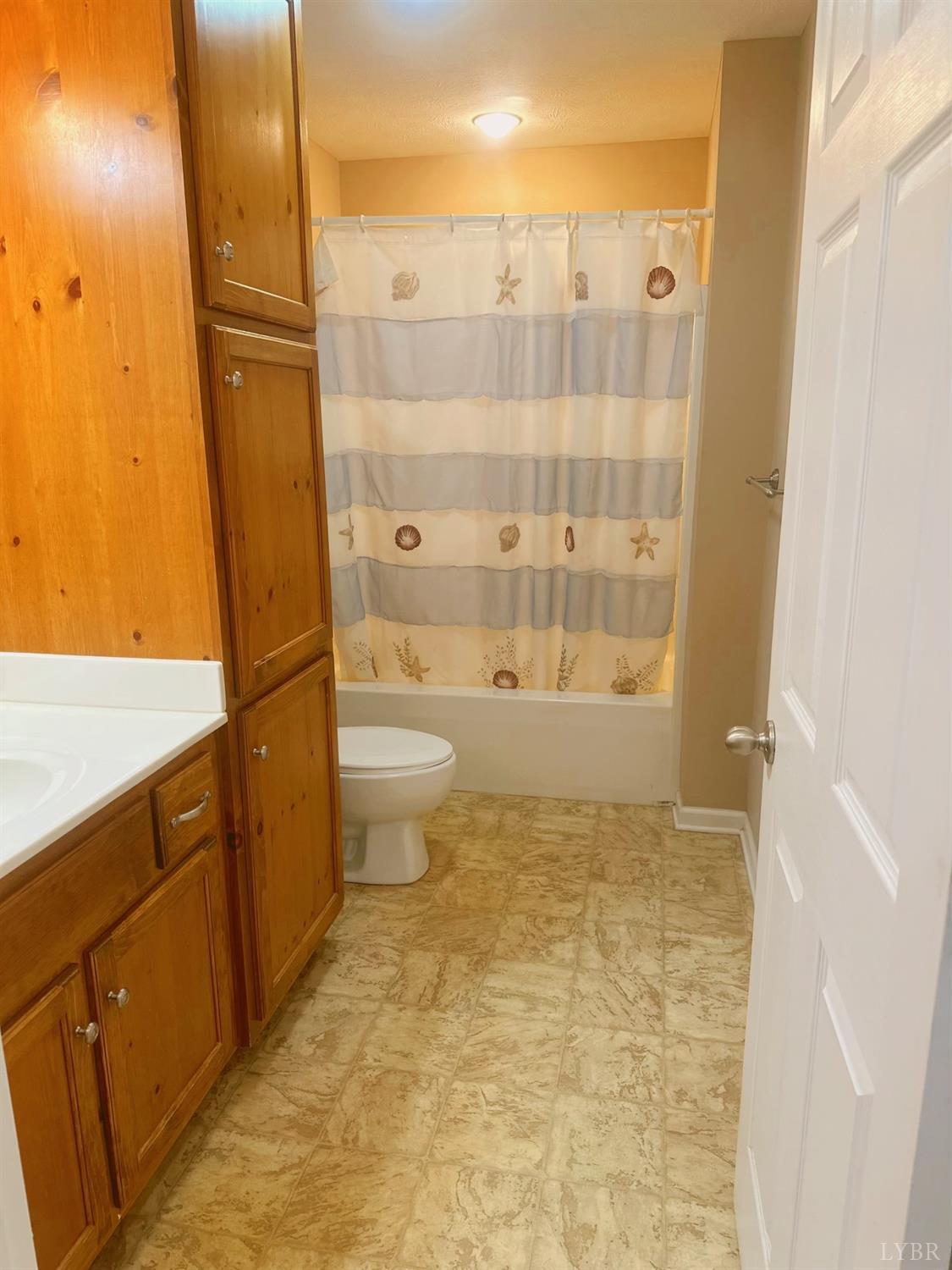 283 Country Estates Road Appomattox, VA 24522 - Photo 15 of 22 a bathroom with a granite countertop sink toilet and shower