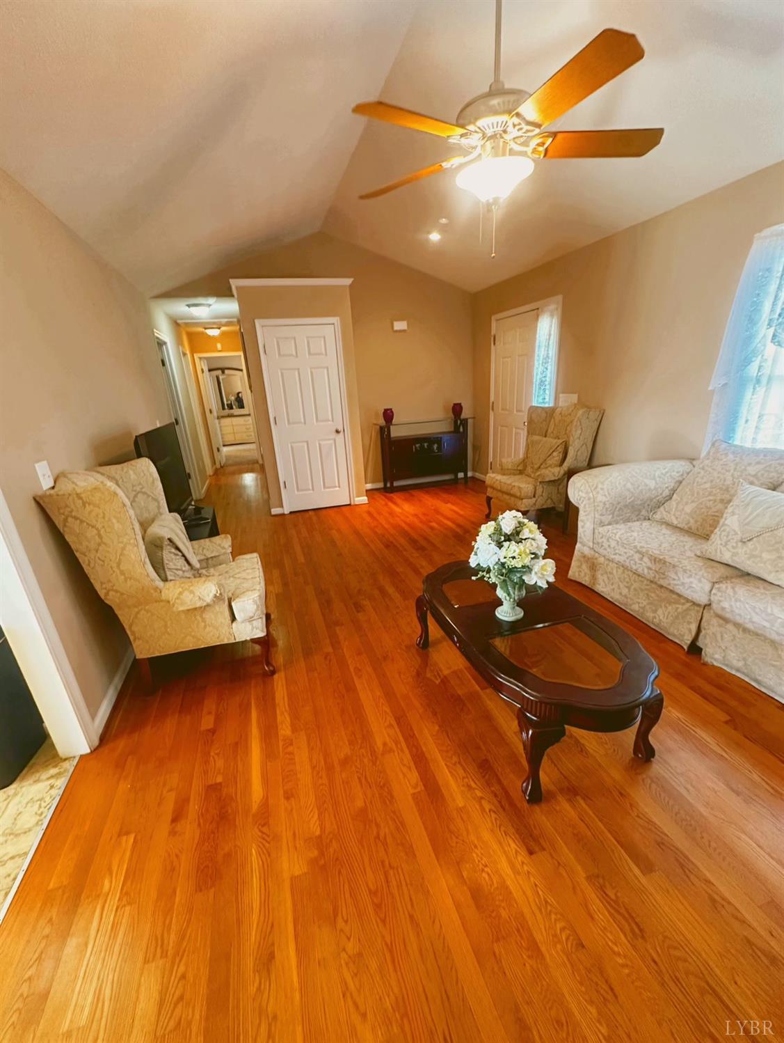 283 Country Estates Road Appomattox, VA 24522 - Photo 4 of 22 a living room with furniture and a dining table with wooden floor