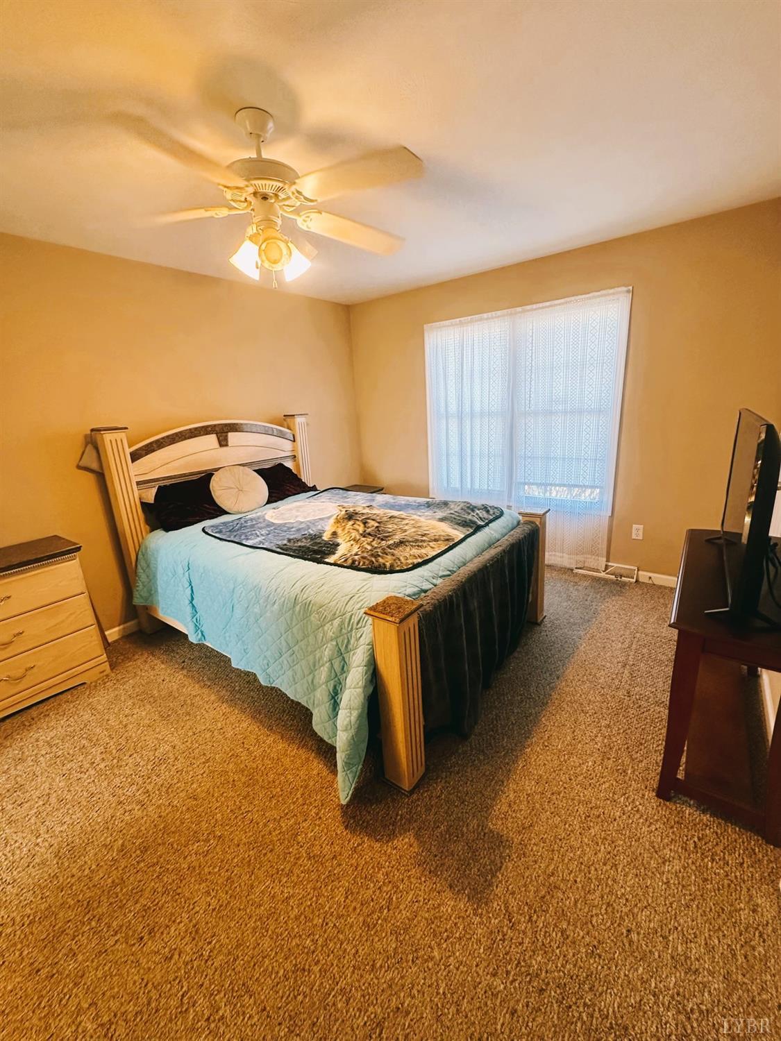 283 Country Estates Road Appomattox, VA 24522 - Photo 10 of 22 a bed sitting in a room next to a lamp