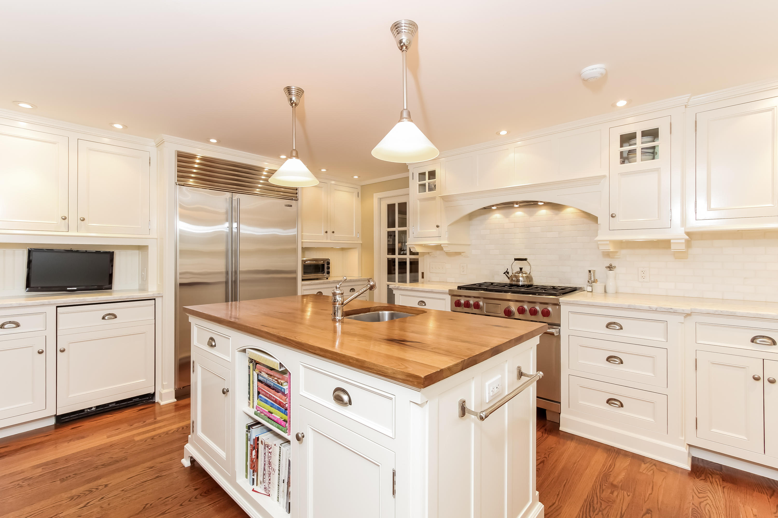 256 Brookside Road Darien, CT 06820 - Photo 13 of 66 a kitchen with a sink a stove a refrigerator and white cabinets