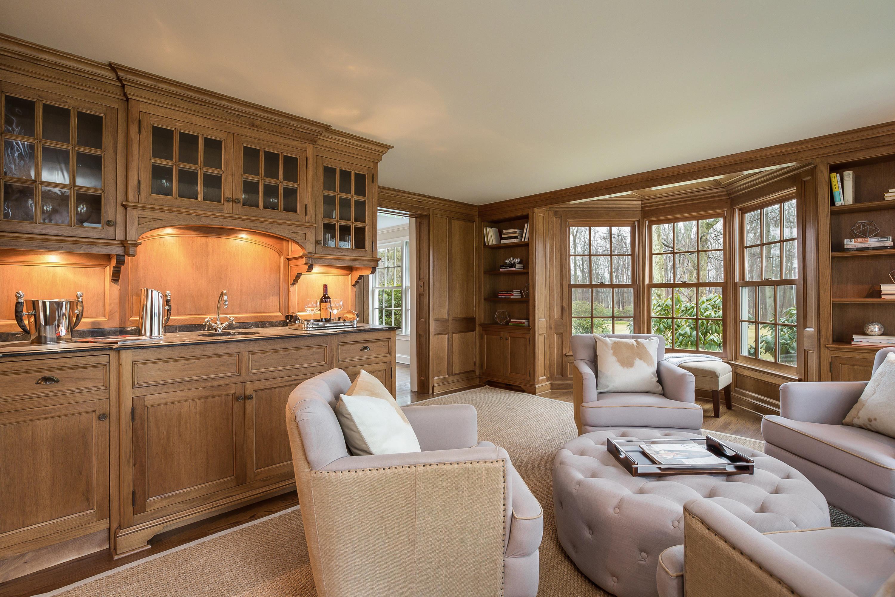 256 Brookside Road Darien, CT 06820 - Photo 19 of 66 a living room with furniture a floor to ceiling window and potted plants
