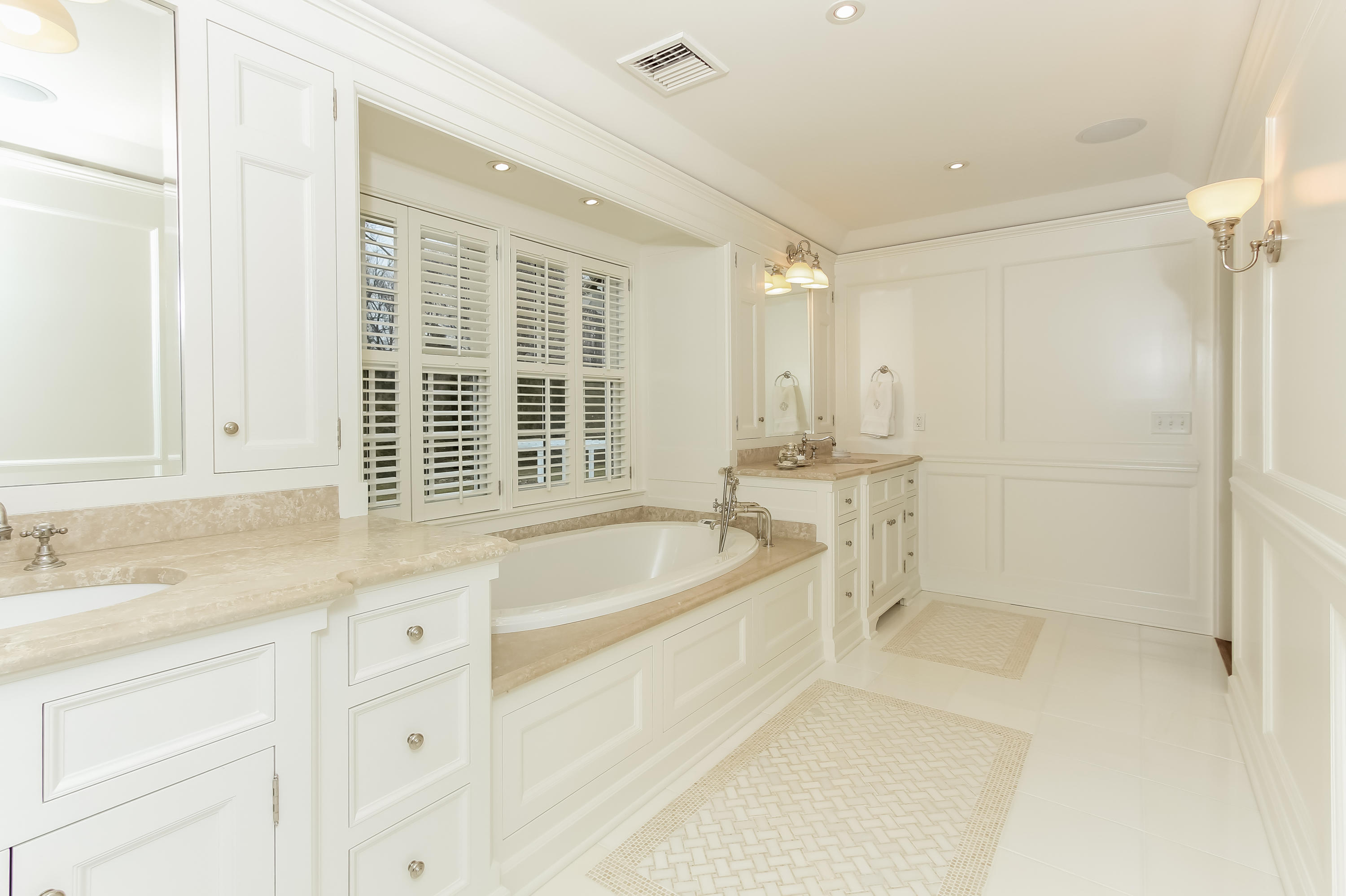 256 Brookside Road Darien, CT 06820 - Photo 30 of 66 a bathroom with a granite countertop sink a bathtub and next to a window