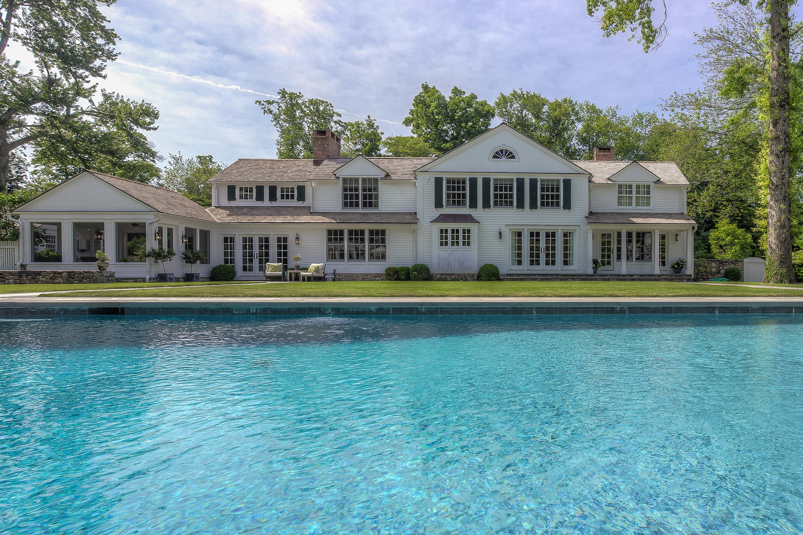 256 Brookside Road Darien, CT 06820 - Photo 33 of 66 a front view of residential houses with yard and outdoor seating