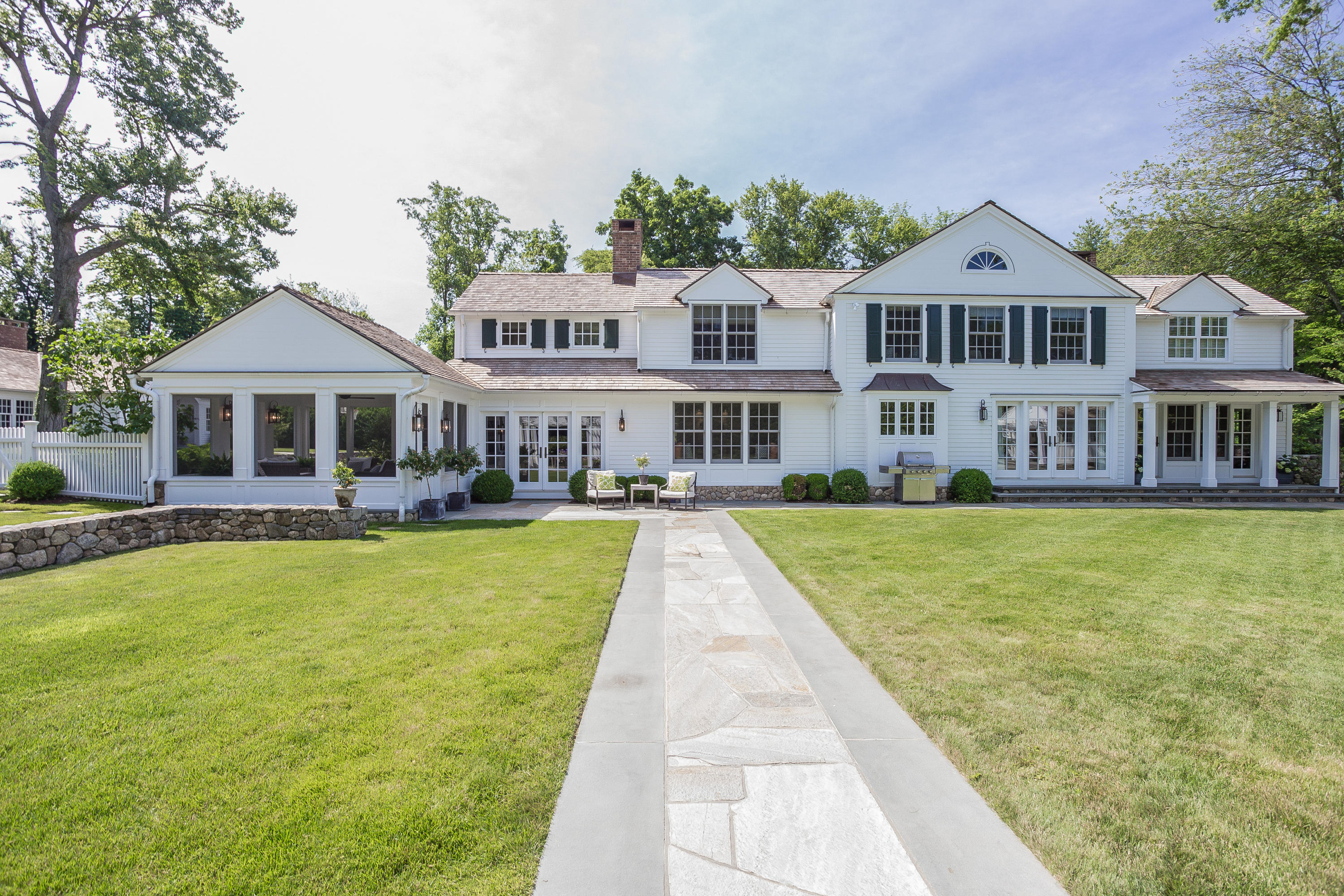 256 Brookside Road Darien, CT 06820 - Photo 38 of 66 a front view of a house with swimming pool and porch