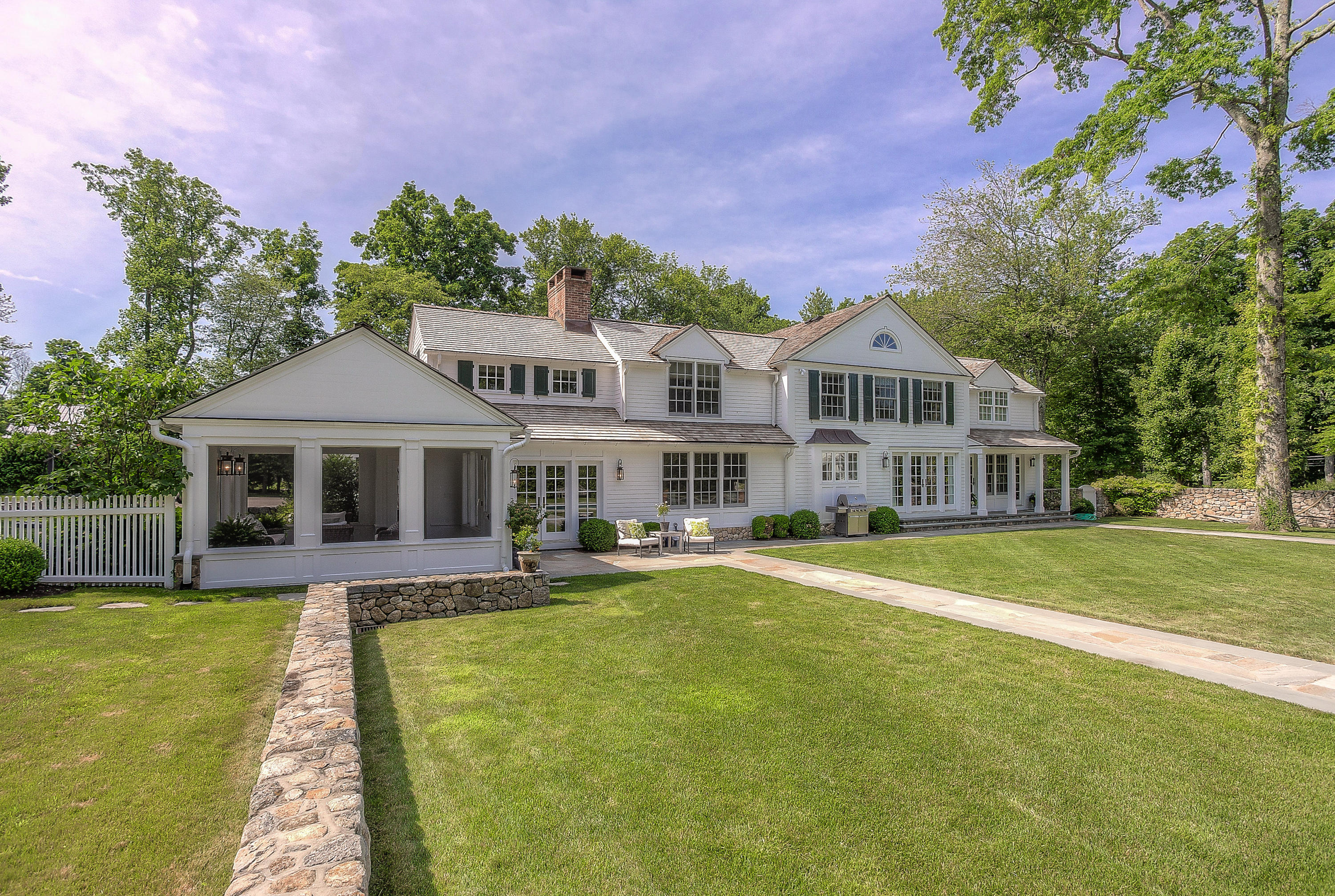 256 Brookside Road Darien, CT 06820 - Photo 39 of 66 a front view of a house with swimming pool and porch