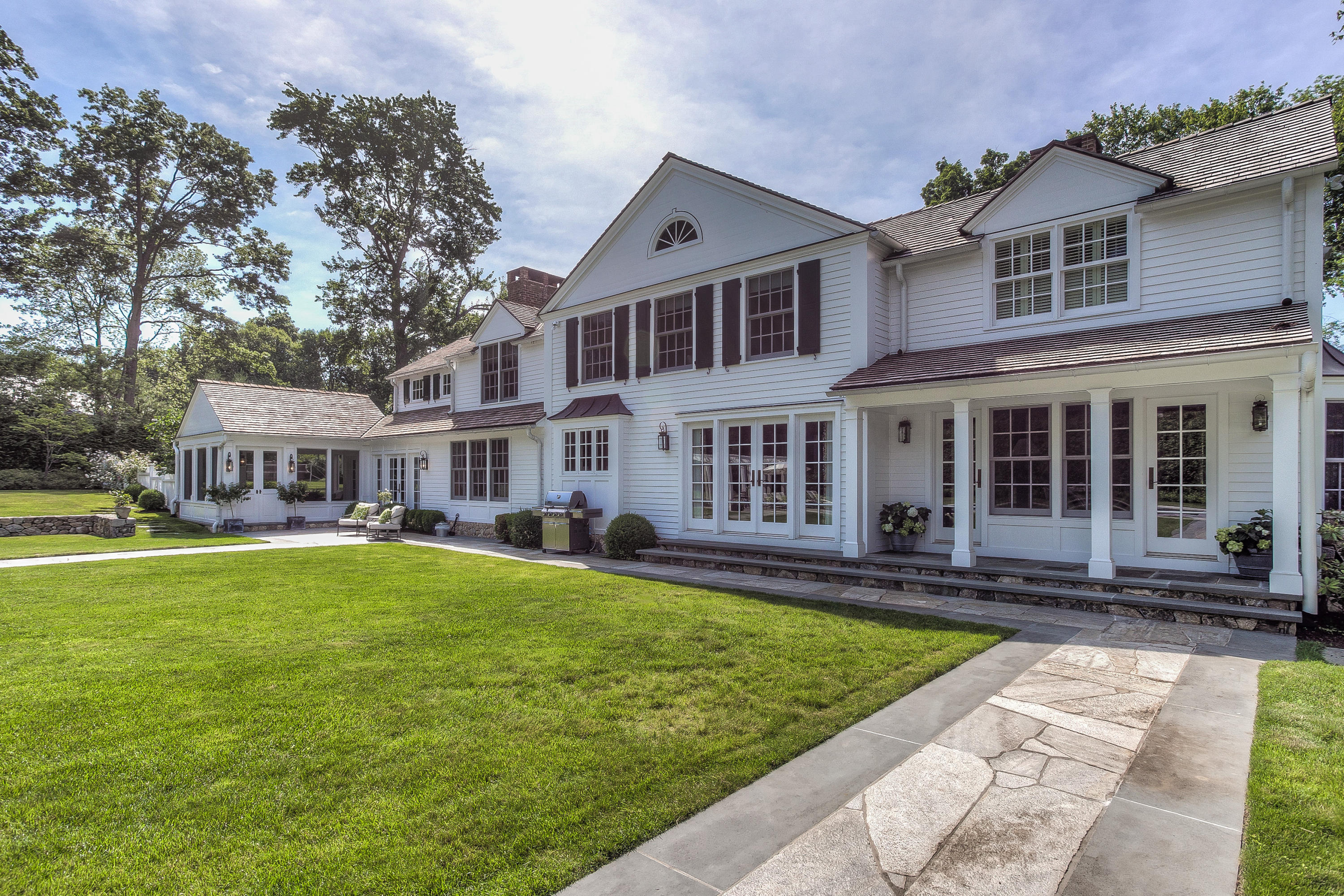 256 Brookside Road Darien, CT 06820 - Photo 40 of 66 a front view of a house with garden and porch