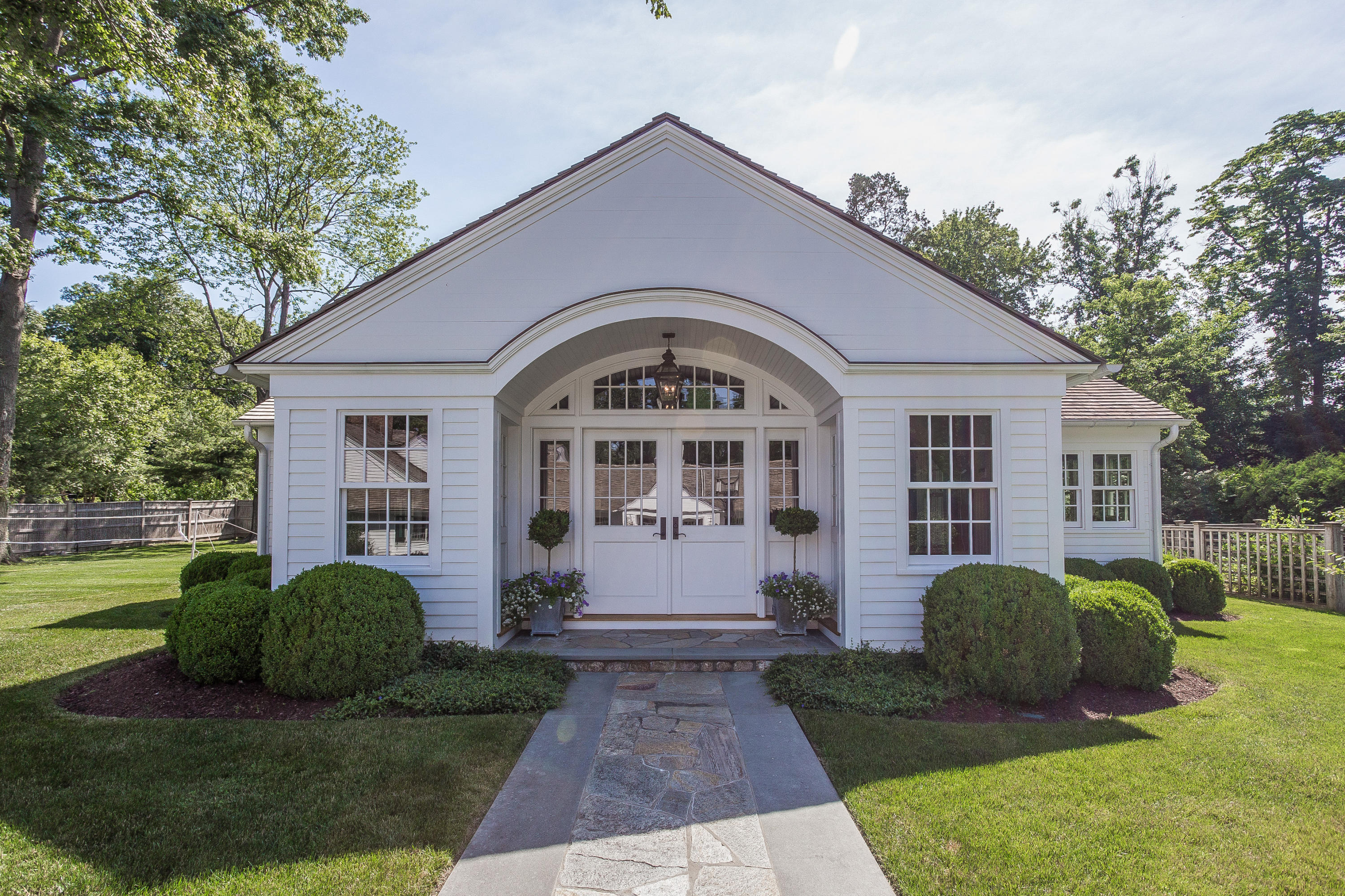 256 Brookside Road Darien, CT 06820 - Photo 42 of 66 a front view of a house with a yard