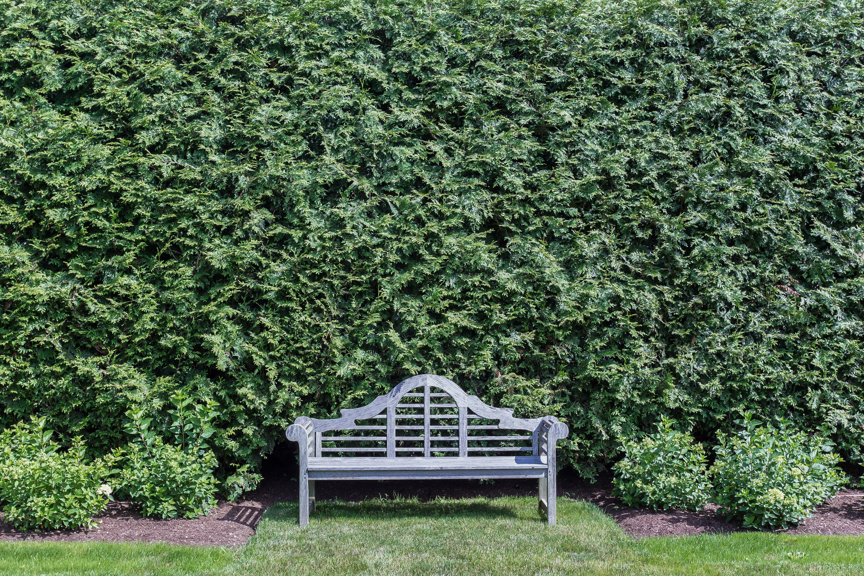 256 Brookside Road Darien, CT 06820 - Photo 55 of 66 a view of a wooden chair and trees in the garden